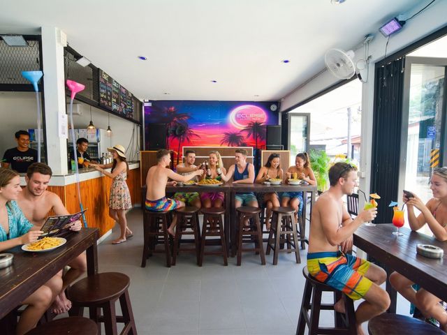 Eclipse bar at night with cocktails and travelers socializing