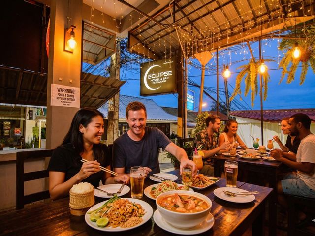 Couple enjoying Thai food at Eclipse terrace at dusk
